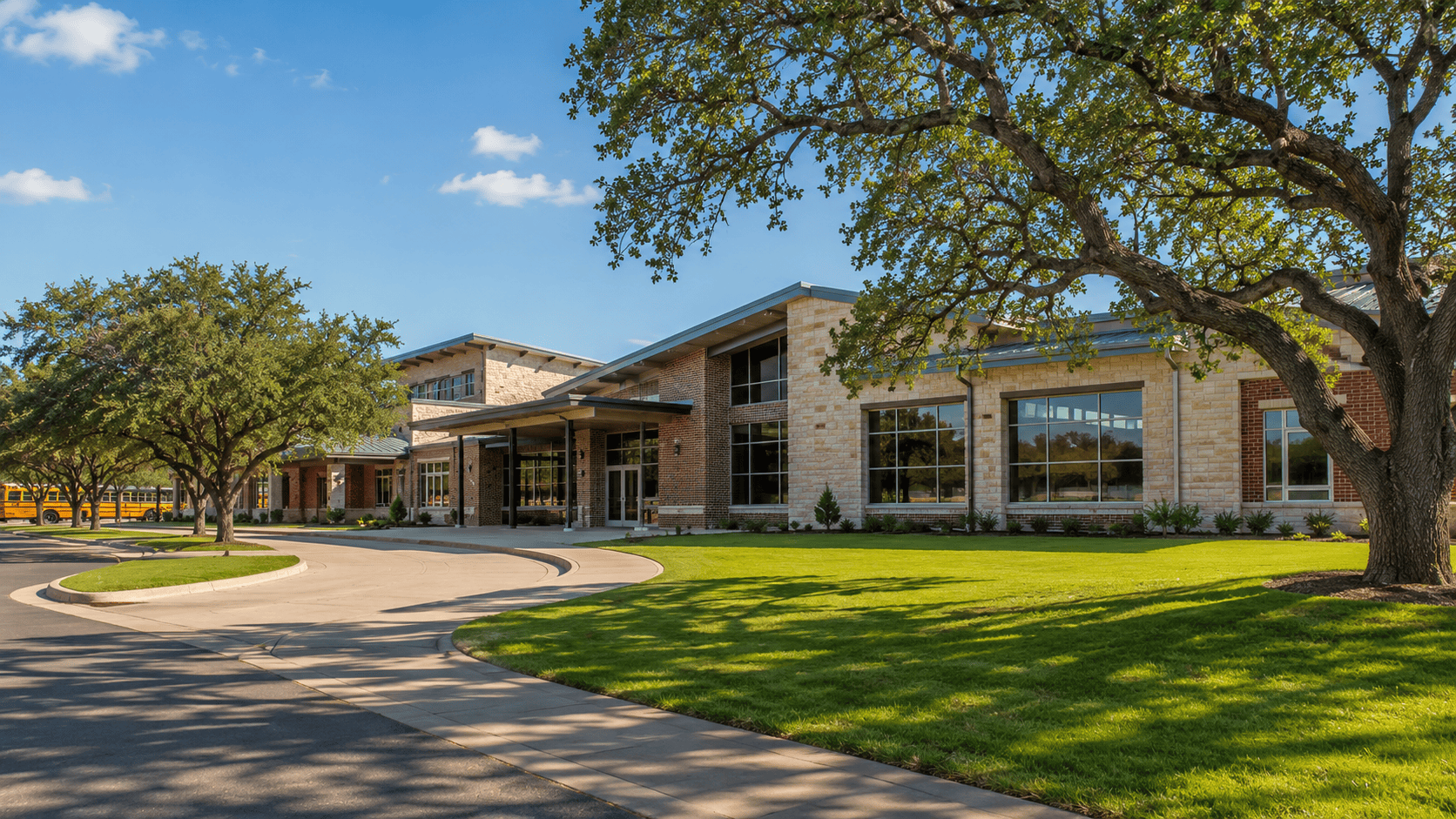 Modern elementary school building in New Braunfels Texas with green landscaping and a bright blue sky, reflecting the growing community
